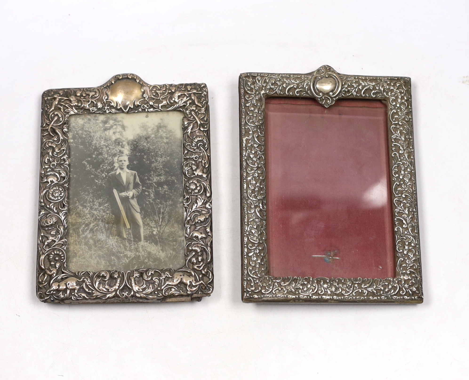 Two early 20th century repousse silver mounted rectangular photograph frames, both approximately 18cm.
